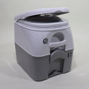 A gray portable toilet, known as a Porta Potty, with its lid open, showcasing the interior and push-button flush mechanism.