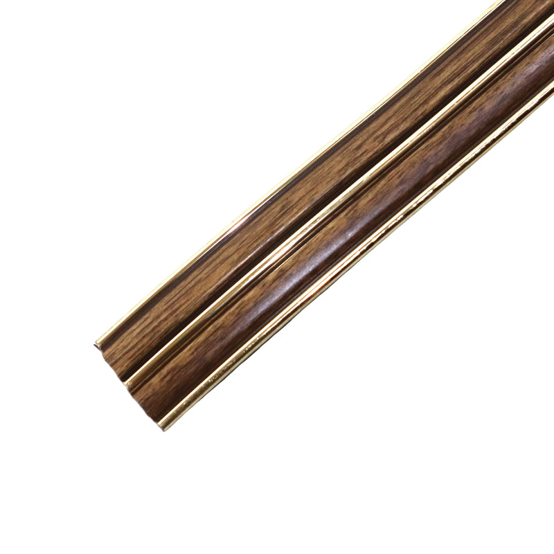 A piece of gold-colored baseboard molding with a wood grain appearance.