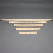 Four beige folding wall hinges laid out on a grey background.