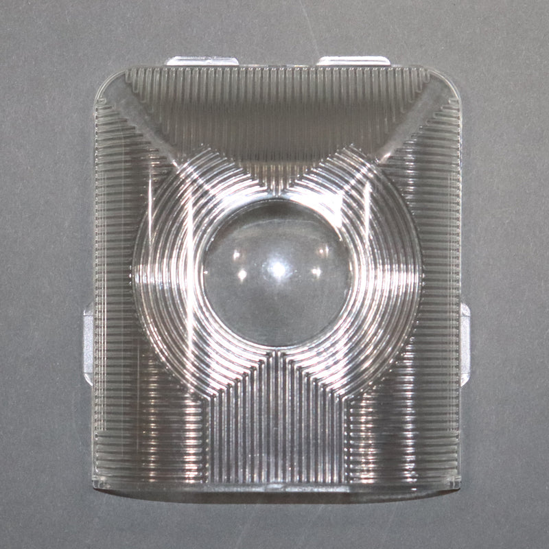 A clear plastic ceiling light lens with a reflective pattern inside.