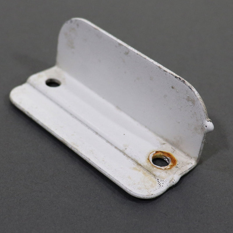 A white metal bracket, used for swing style doors, with visible signs of wear.