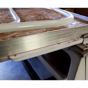 A close-up image of a white plastic bed slide rail attached to a mechanism, presumably part of a recreational vehicle's bed extension system.